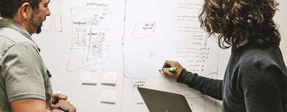 Two people reviewing common cloud migration challenges