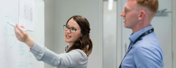 Woman explaining cloud security best practices to a man