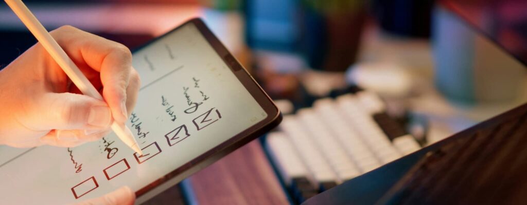 Cybersecurity Checklist for Small Businesses Business owner creating a cybersecurity checklist on an ipad